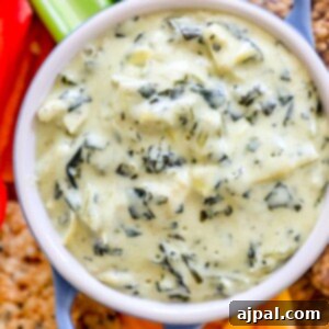 A low carb spinach and artichoke dip served with keto crackers and celery.
