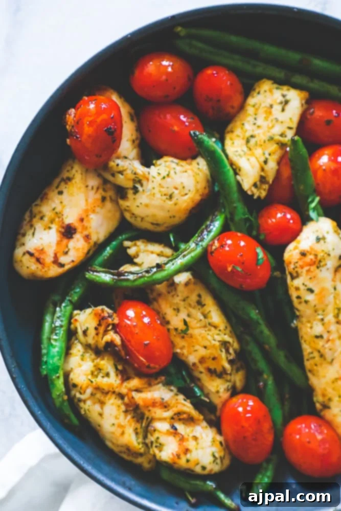 One Pan Tuscan Chicken and Vegetables 2 chicken, green beans, and tomatoes in a pan