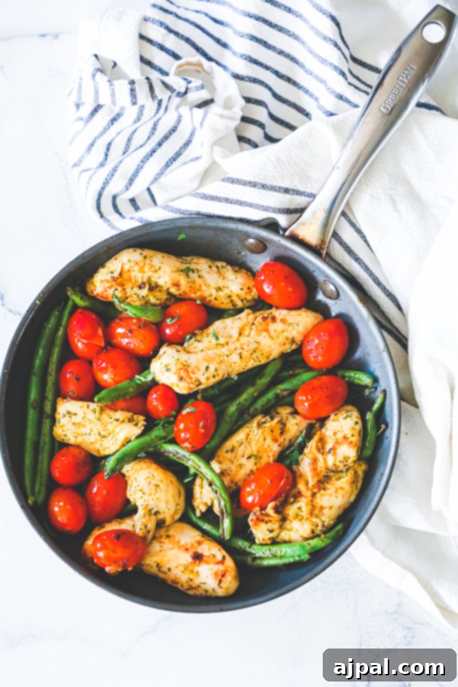 One Pan Tuscan Chicken and Vegetables 3 chicken, green beans, and tomatoes in a green pan
