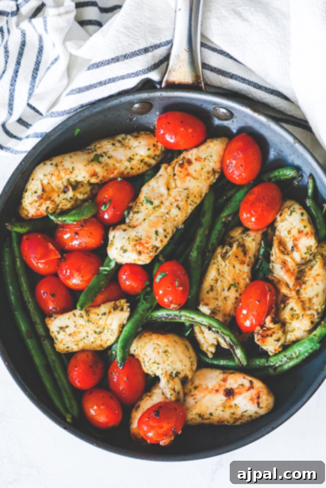 One Pan Tuscan Chicken and Vegetables 7 chicken, green beans, and tomatoes in a green pan