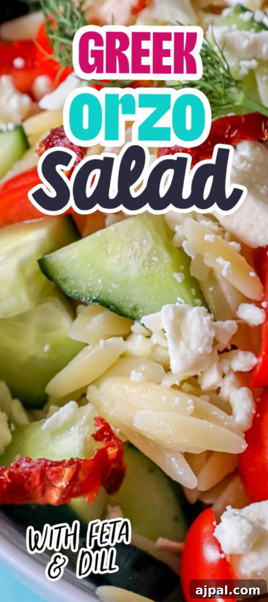 A full bowl of Greek Orzo Pasta Salad with cherry tomatoes, olives, sun-dried tomatoes, feta cheese, cucumbers, and fresh dill.