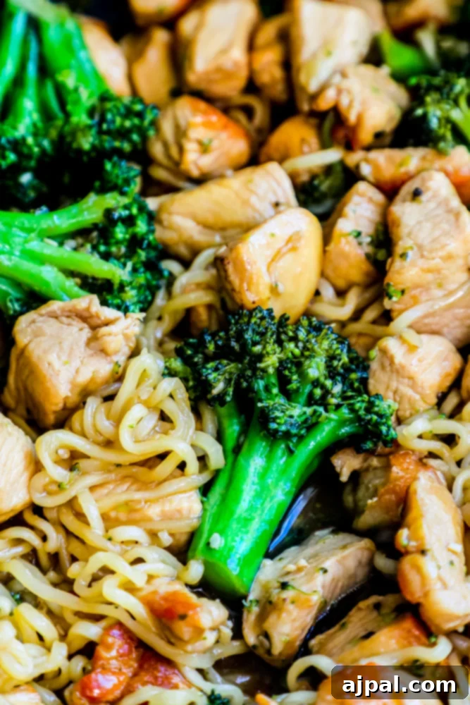 Homemade Teriyaki Chicken Noodles 2 Delicious chicken teriyaki noodles with chicken breast and broccoli in a bowl, garnished with sesame seeds and green onions
