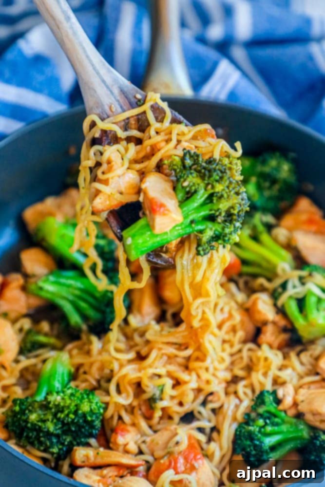 Homemade Teriyaki Chicken Noodles 3 Chicken and broccoli teriyaki stir fry with ramen noodles in a large pot with a serving spoon