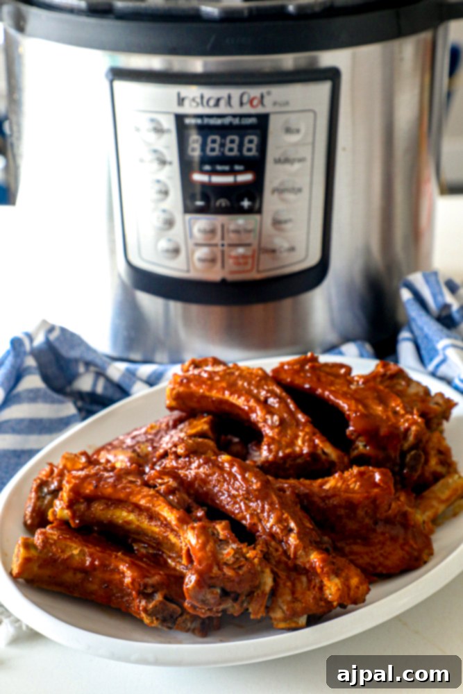 Melt-in-Your-Mouth Instant Pot Keto Ribs 2 Mouth-watering Instant Pot Keto Ribs ready to serve, with the Instant Pot in the background.