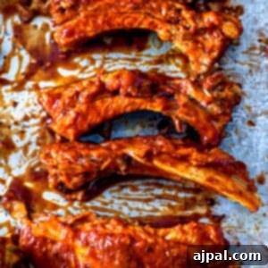 Bbq ribs on a baking sheet using the best instant pot keto ribs recipe.
