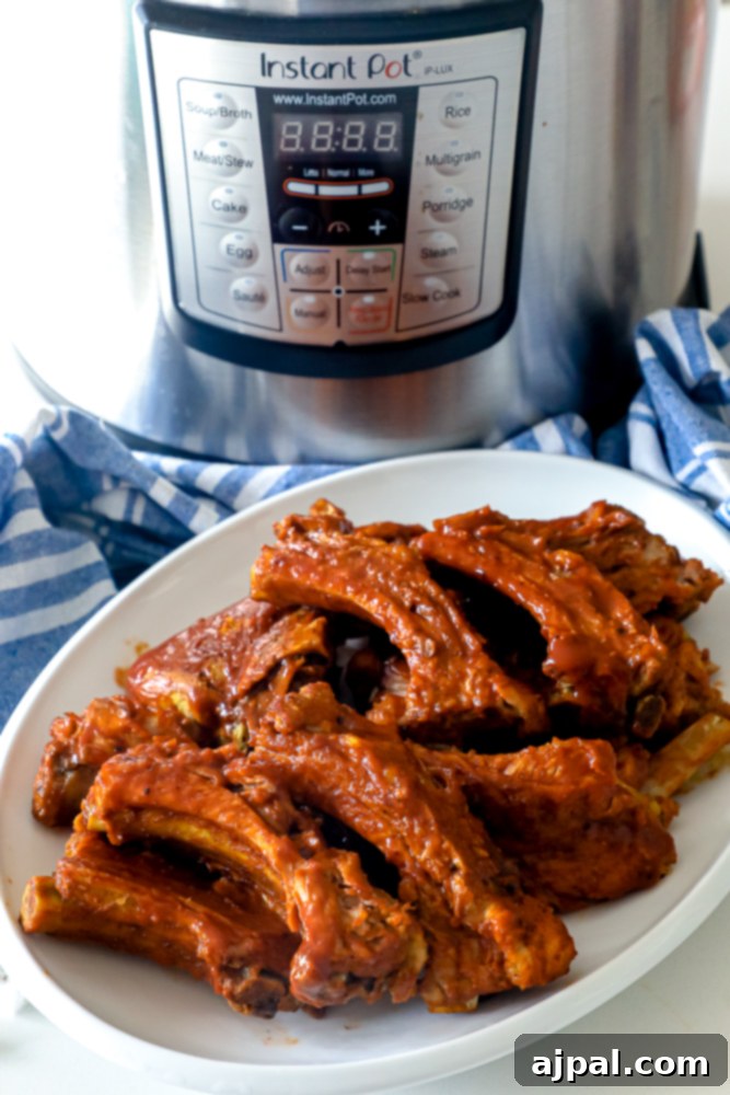 Melt-in-Your-Mouth Instant Pot Keto Ribs 6 A plate of savory Keto BBQ ribs positioned in front of an Instant Pot, highlighting the finished dish.