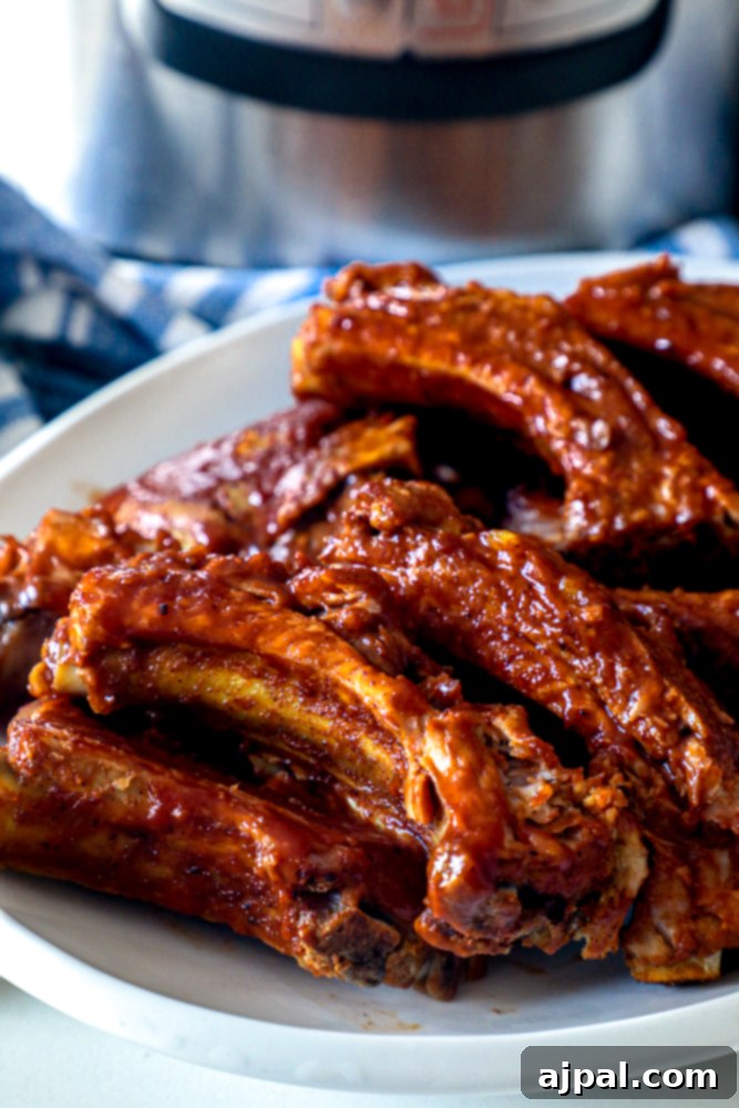 Melt-in-Your-Mouth Instant Pot Keto Ribs 7 Plated Instant Pot Keto Ribs served beautifully in front of a slow cooker, showcasing their readiness to enjoy.