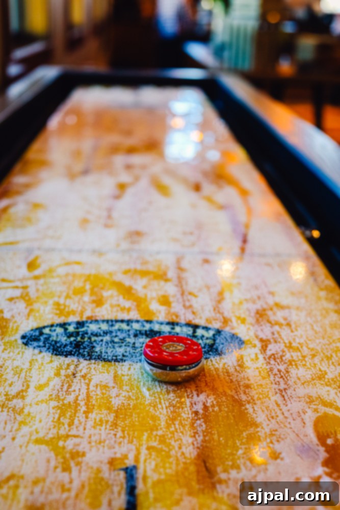 Ranahan By Welk Resorts: Breckenridge Colorado 5 A vibrant shuffleboard table with a red puck awaits players at The Ranahan By Welk Resorts Breckenridge Colorado, offering a fun indoor activity for guests.