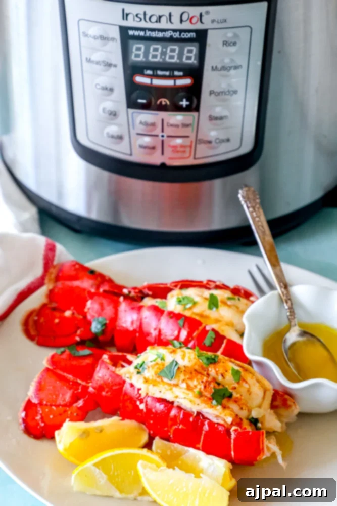 Best Easy Instant Pot Lobster Tail with lemons in front of an instant pot.