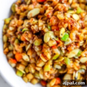 A vegan fried rice bowl made with a mixture of vegetables and seeds.