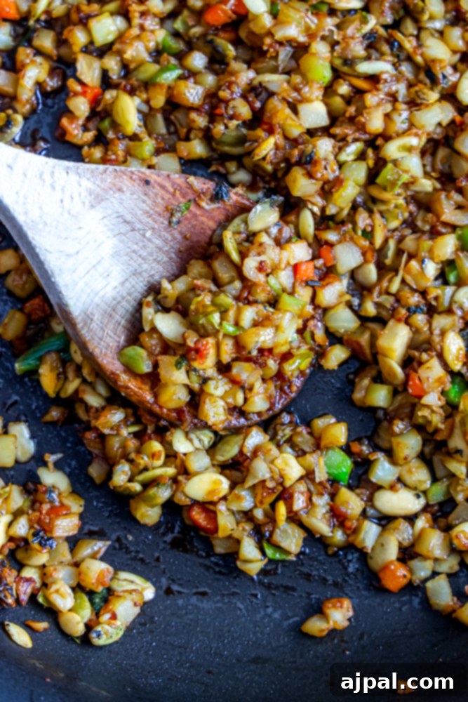 fried rice with onion, cabbage, and nuts with spoon in it