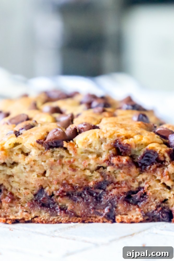 Cross-section of warm chocolate chip banana bread showing melted chocolate chips and moist texture
