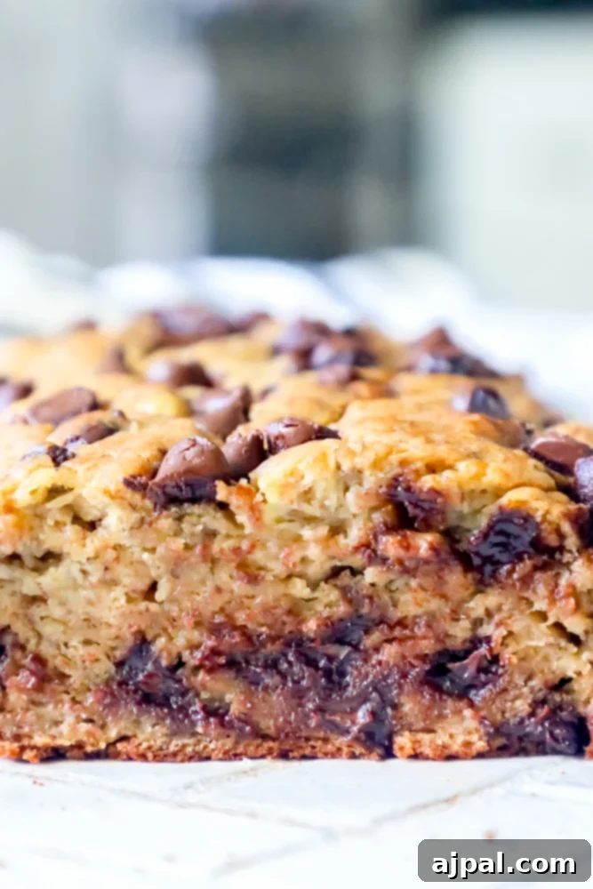 Picture of melted chocolate chips inside a warm slice of banana bread, ready to be enjoyed
