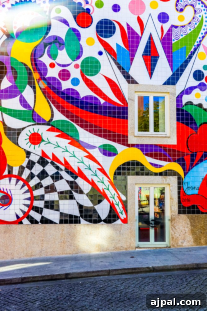 Crafting the Perfect Port and Tonic 20 A colorful and vibrant wall mural adorning the side of a building in Porto, Portugal, adding artistic flair to the city streets.