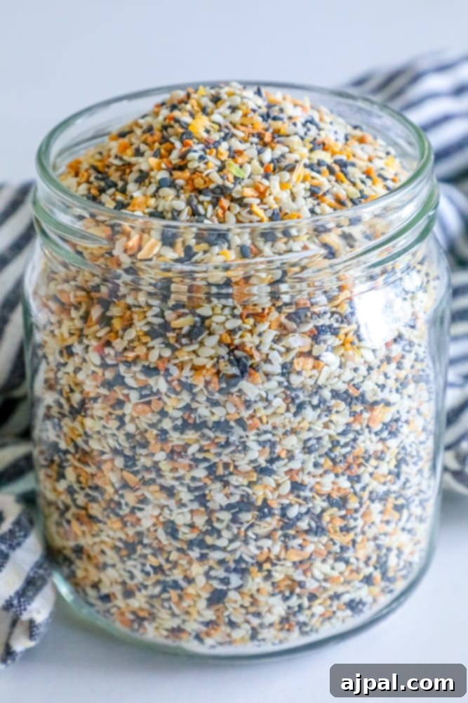 Crafted Everything Bagel Seasoning Blend 2 A glass jar filled with homemade Everything Bagel Seasoning mix, featuring visible sesame seeds, poppy seeds, and spices.