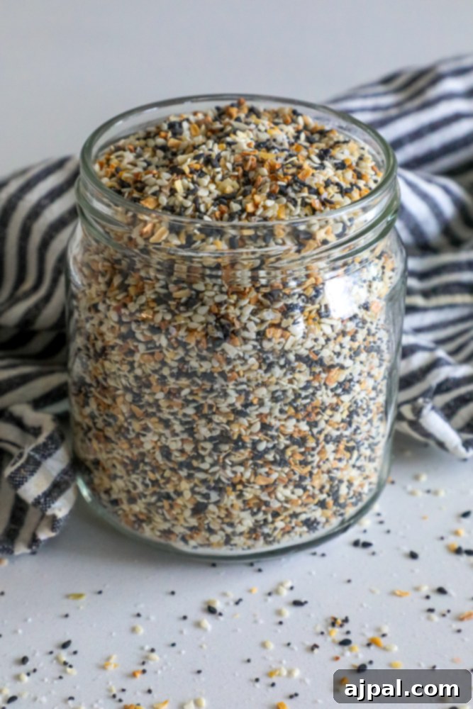 Crafted Everything Bagel Seasoning Blend 5 A charming glass jar of homemade Everything Bagel Seasoning mix, ready to be used in any dish.