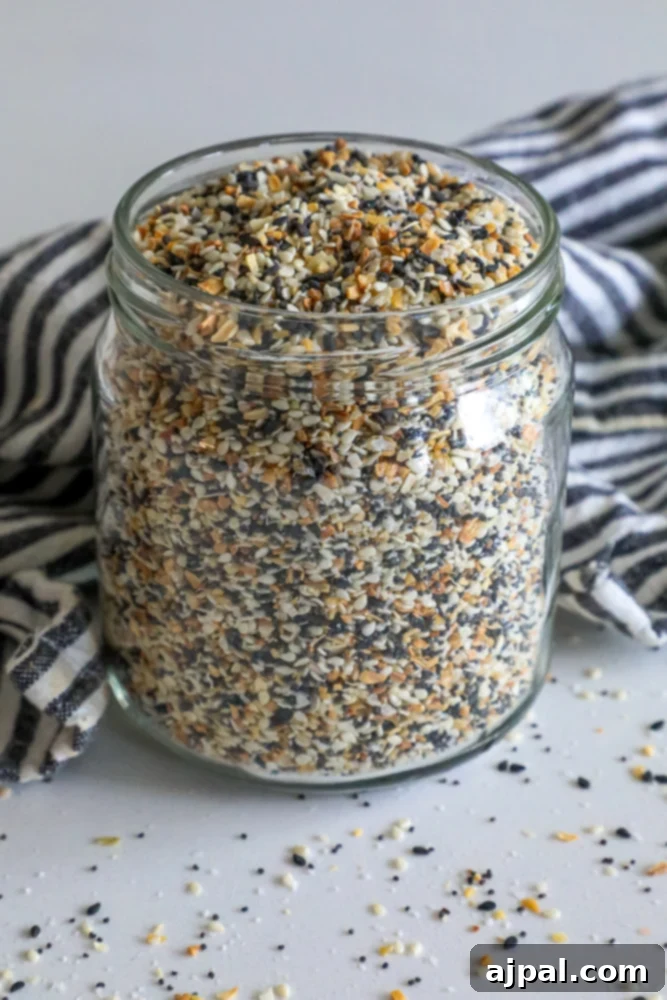 Ultimate Everything Bagel Seasoning Blend 5 A jar of sesame seeds, poppy seeds, and spices, beautifully arranged for an Everything Bagel Mix.