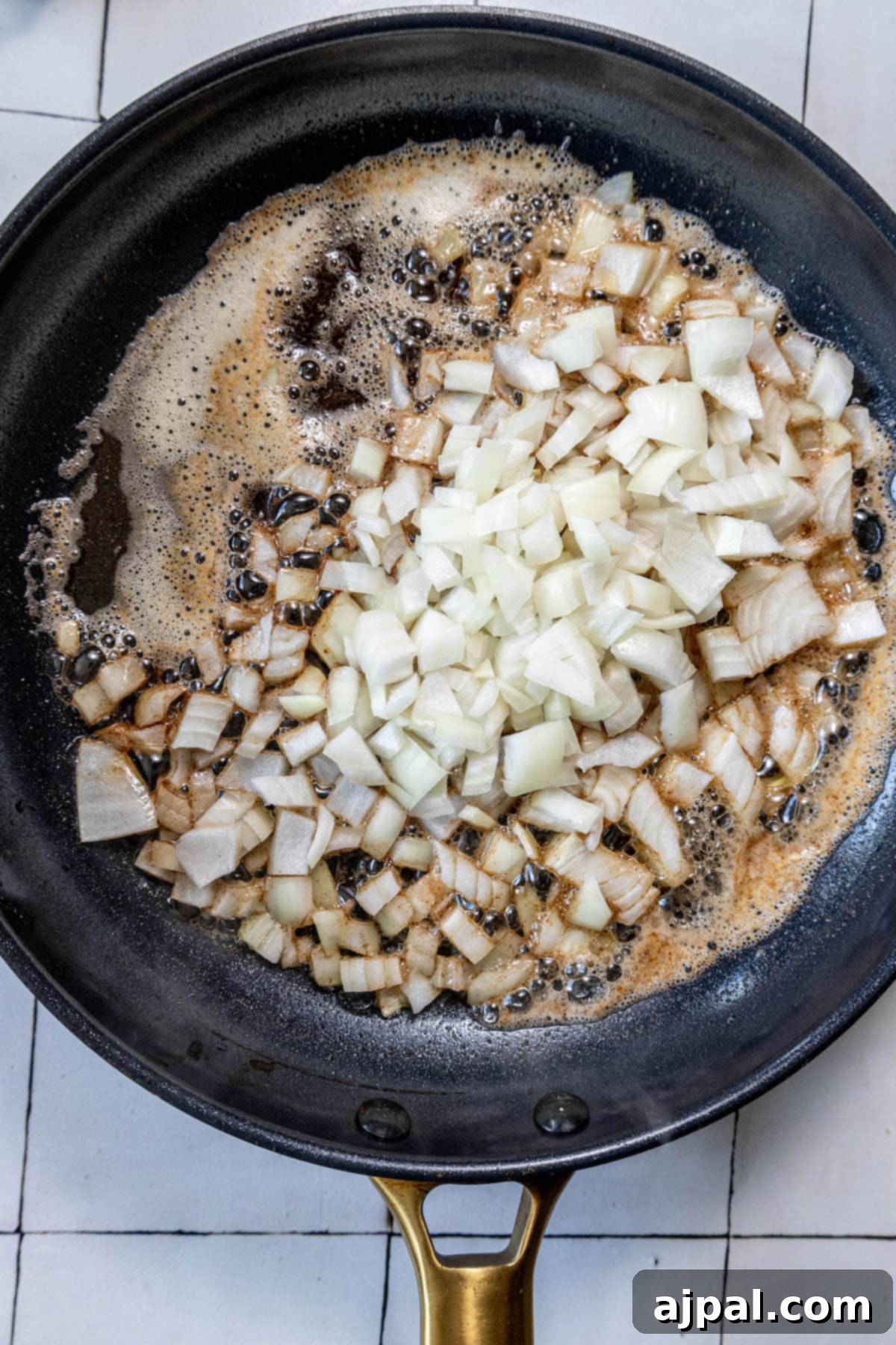 An easy side dish recipe for sautéed zucchini and squash, cooked in a frying pan with onions.