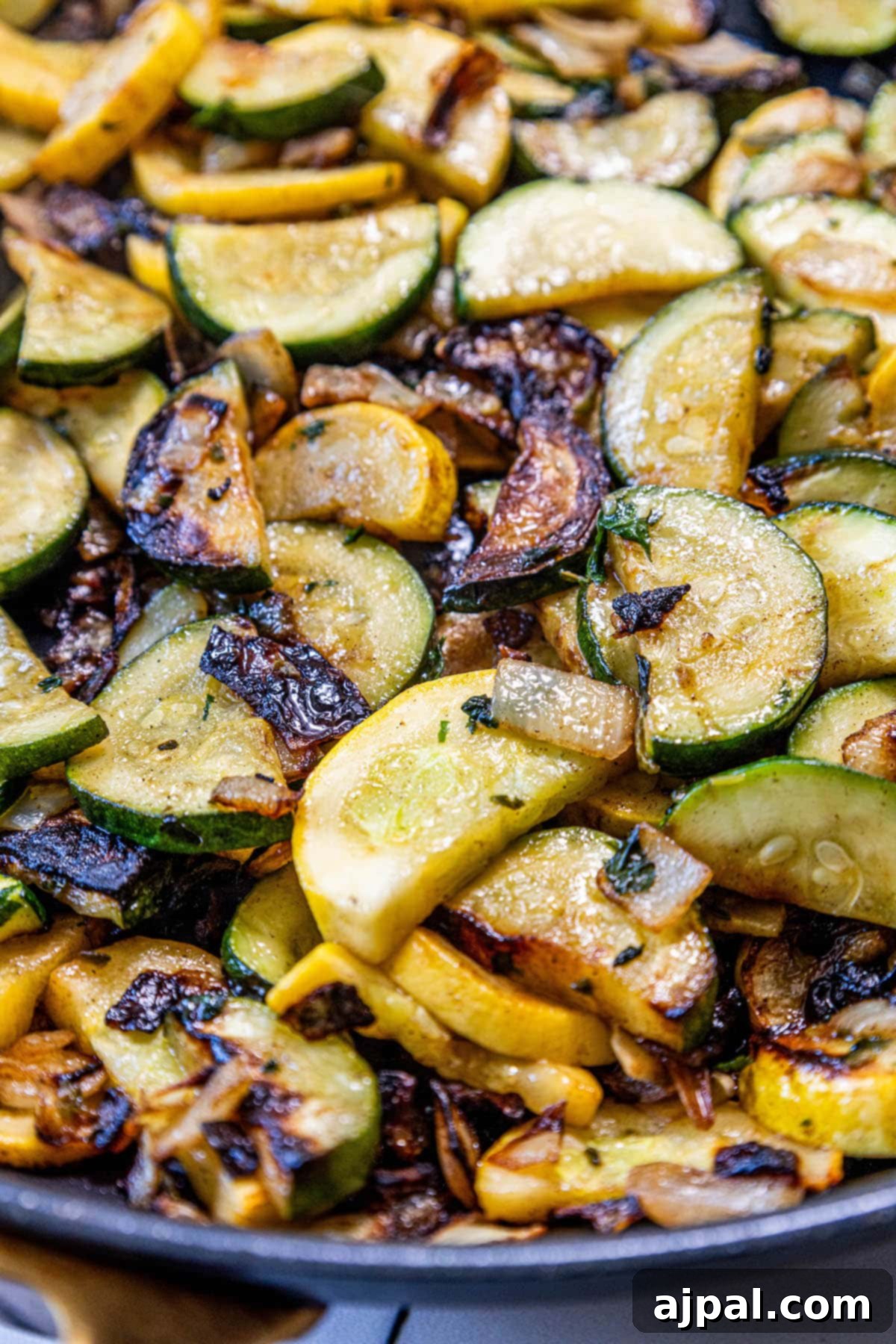 A keto recipe for pan fried zucchini and squash, served as a side dish.