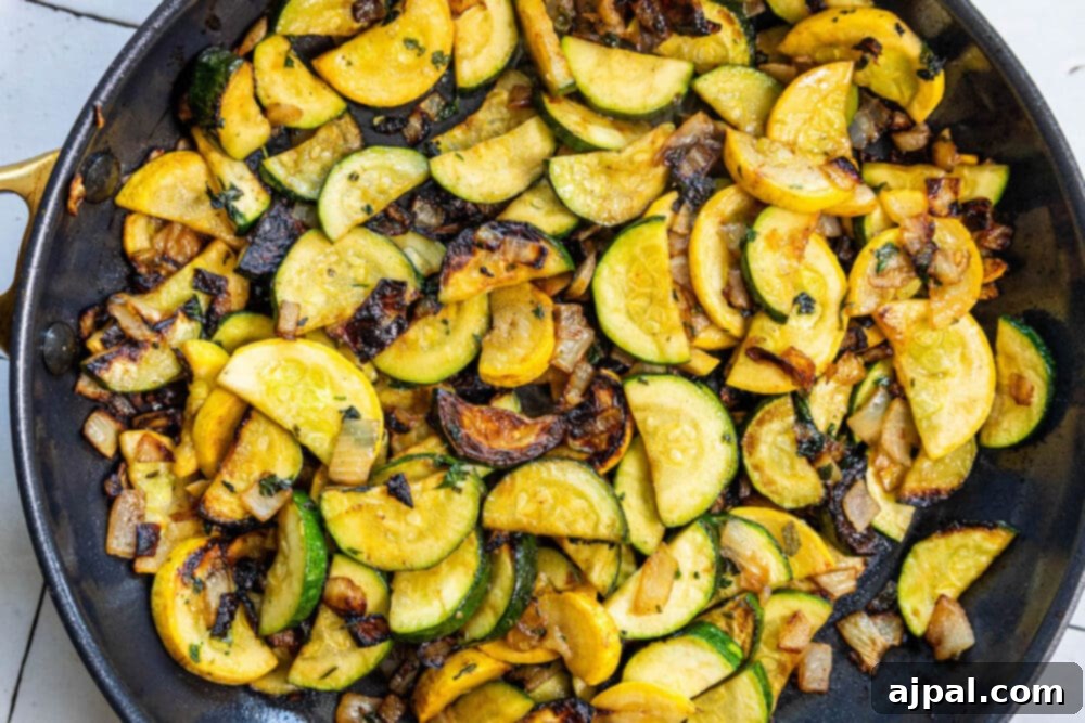 A keto recipe featuring pan-fried zucchini squash and mushrooms in a skillet.