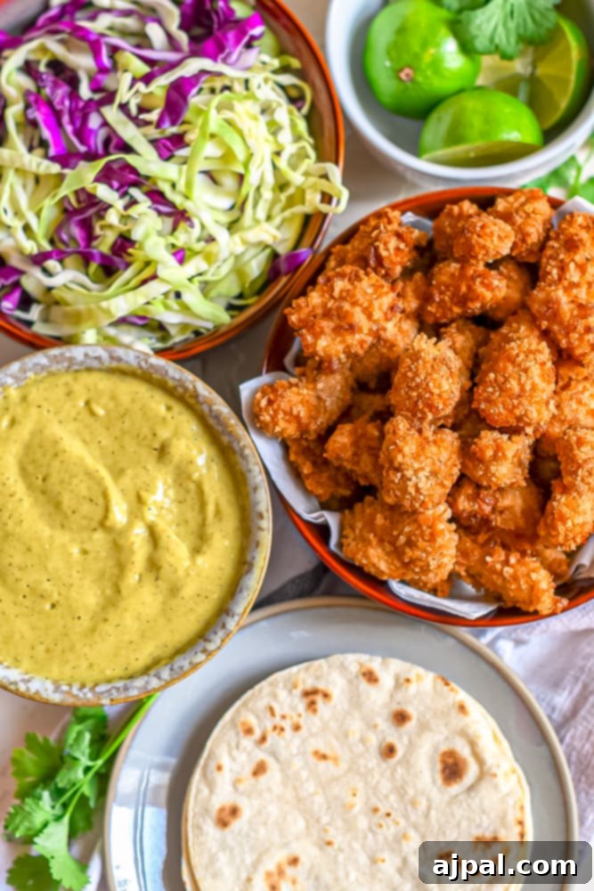 Crispy Chicken Tacos 9 Beautifully plated Mexican fried chicken tacos, artfully arranged and accompanied by a side of crisp slaw and creamy guacamole, perfect for serving.