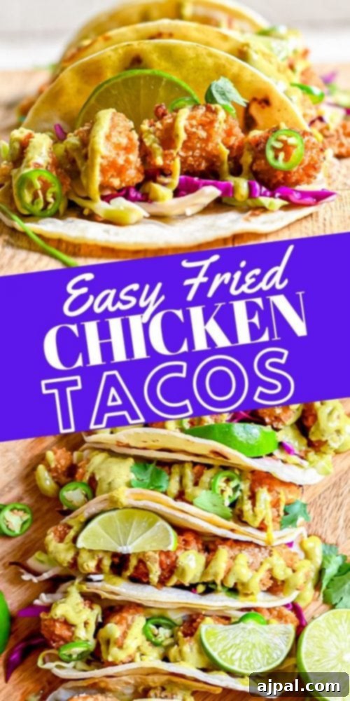 A vertical shot of delicious fried chicken tacos beautifully arranged on a cutting board, garnished and ready to eat.