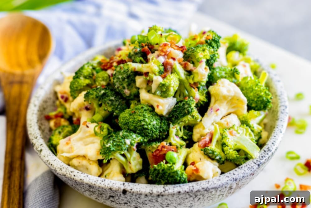 creamy broccoli keto salad in a bowl with a spoon on the side
