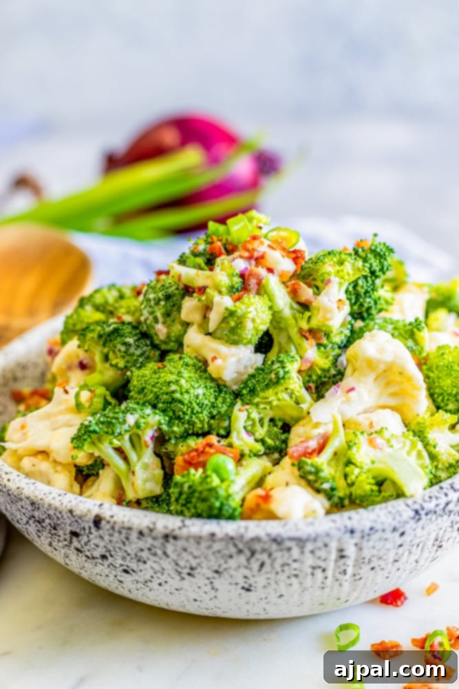broccoli and cauliflower salad in a bowl with creamy dressing