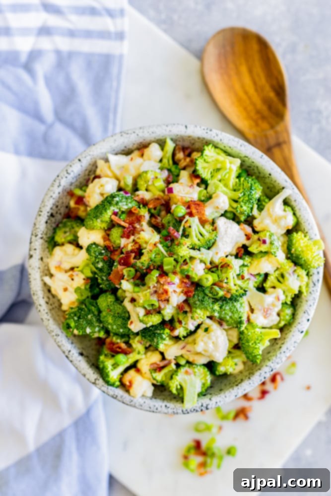 broccoli salad in a bowl tossed in creamy dressing