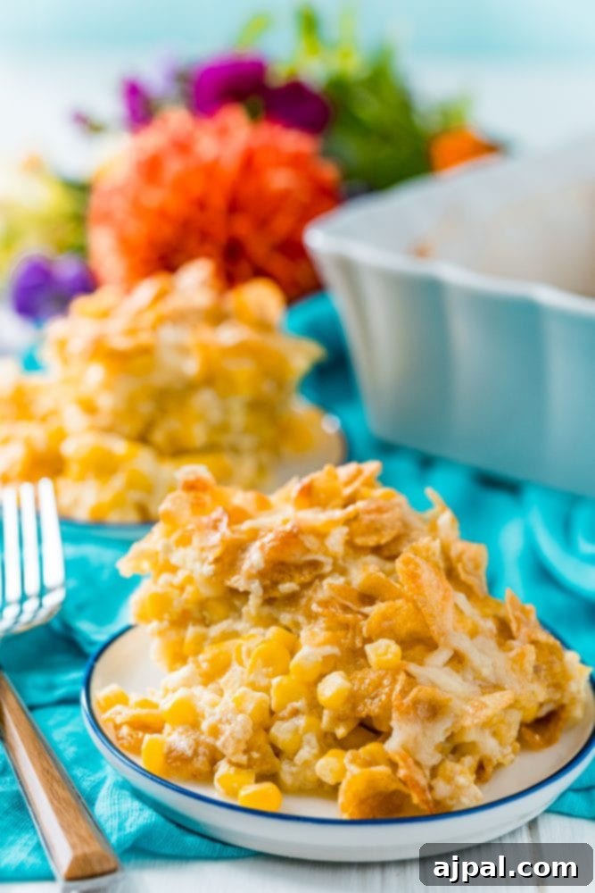Golden Scalloped Corn Bake 11 baked scalloped corn with crunchy cornflakes on a white plate