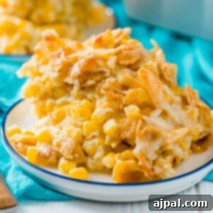Golden Scalloped Corn Bake 13 baked scalloped corn with crispy cornflakes on a plate on a table