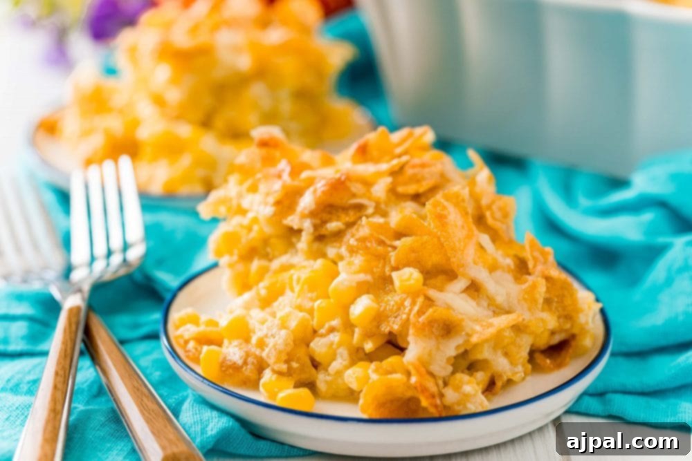Golden Scalloped Corn Bake 3 scalloped corn with cornflakes in a white plate with two forks next to it