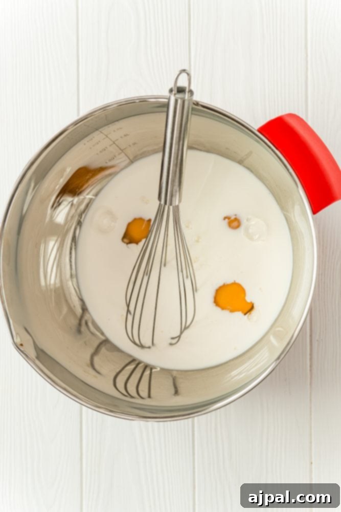 Golden Scalloped Corn Bake 5 bowl with milk, eggs in it