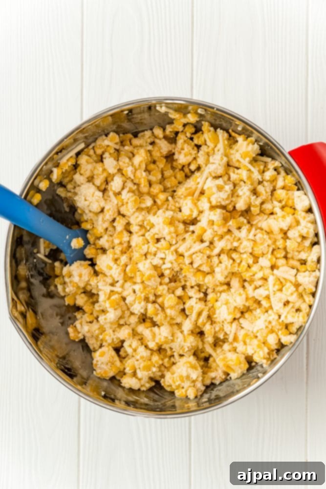 Golden Scalloped Corn Bake 6 corn and cornflakes mixed with milk and eggs in a bowl