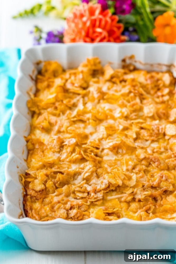 Golden Scalloped Corn Bake 8 baked scalloped corn with cornflakes on top in a white dish