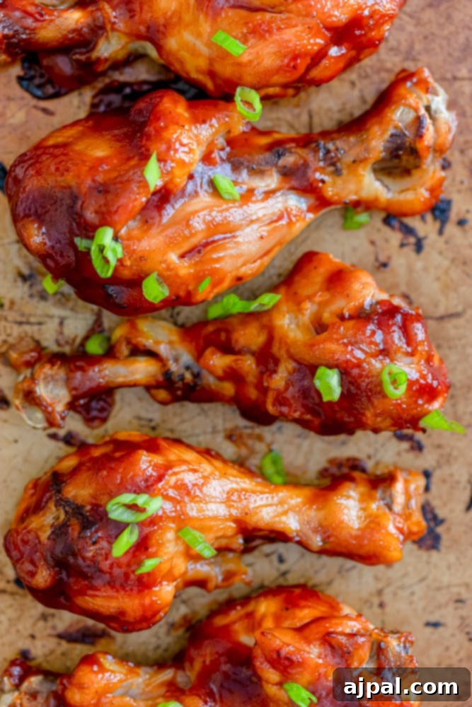 A tray of freshly cooked BBQ chicken legs, ready for a final basting and serving.