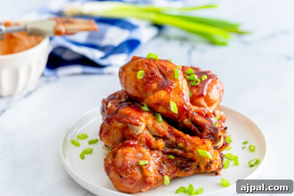 Beautifully glazed Keto BBQ chicken legs on a white plate, ready for a low-carb feast.