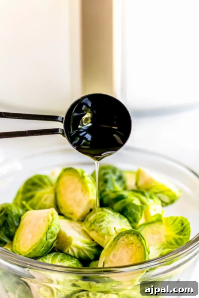 Air fried brussels sprouts being drizzled with olive oil