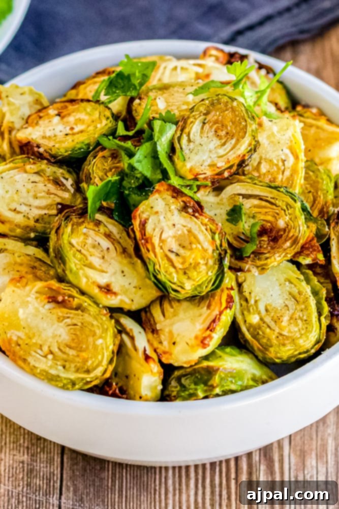 cooked browned brussels sprouts in a bowl with parsley
