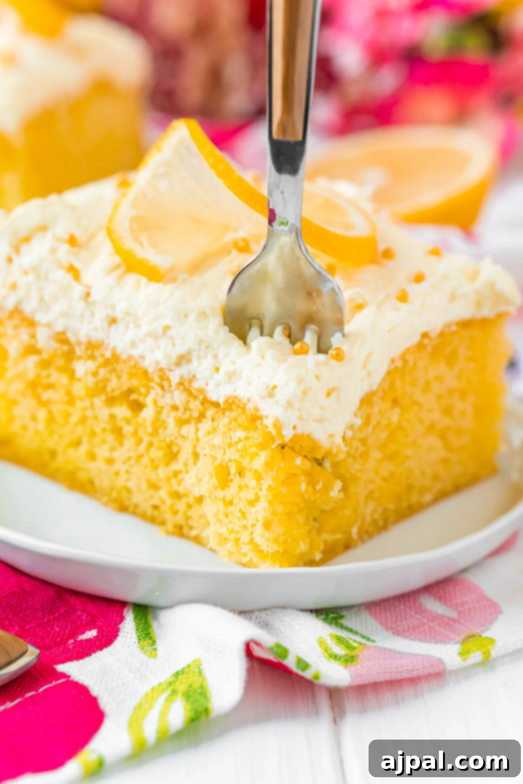 Effortless Lemon Jello Poke Cake 2 A slice of Jello Poke Cake on a plate.