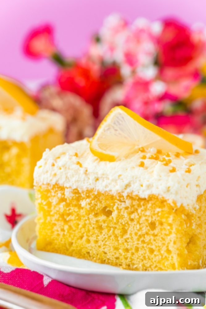 Effortless Lemon Jello Poke Cake 11 A slice of lemon poke cake on a plate.