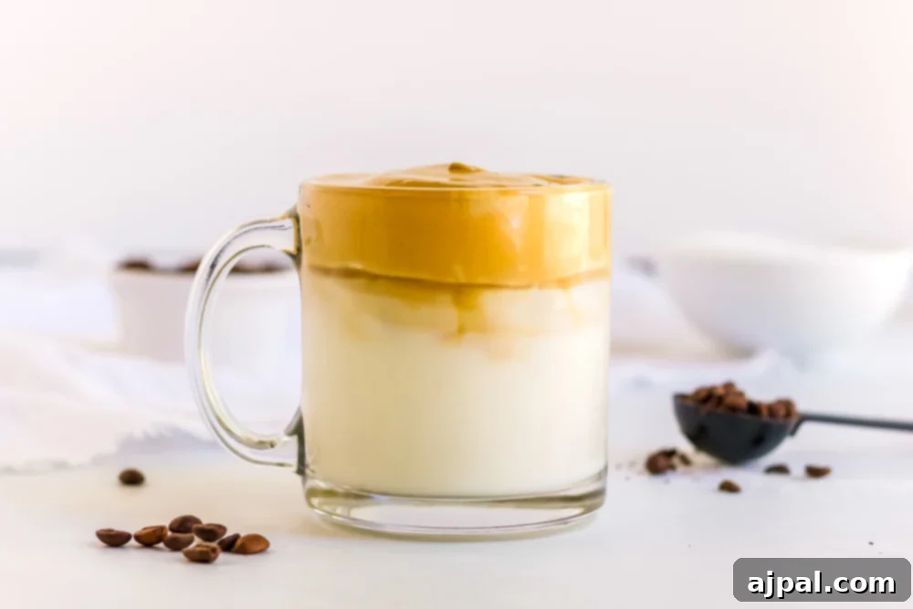 Finished glass of creamy keto Dalgona coffee with caramel-colored foam.