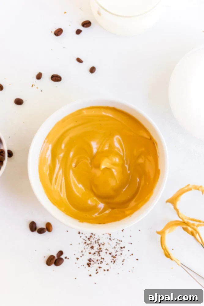 The whipped Dalgona coffee foam in a bowl, showing its light and fluffy texture.