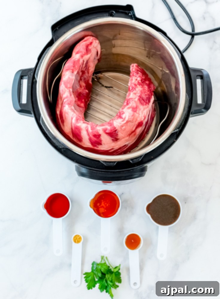 Instant Pot Sticky Asian BBQ Ribs 3 Instant Pot containing raw ribs alongside small dishes of Asian-inspired sauces and spices.