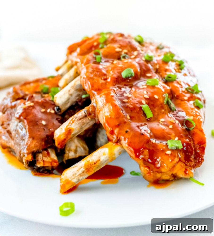 Instant Pot Sticky Asian BBQ Ribs 4 A plate of sticky Asian Instant Pot ribs, glistening with sauce and topped with fresh green onions, ready to be enjoyed.