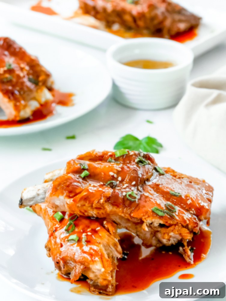 Instant Pot Sticky Asian BBQ Ribs 9 A glistening plate of Instant Pot Asian Sticky Ribs, rich with sauce, promising a delightful culinary experience.