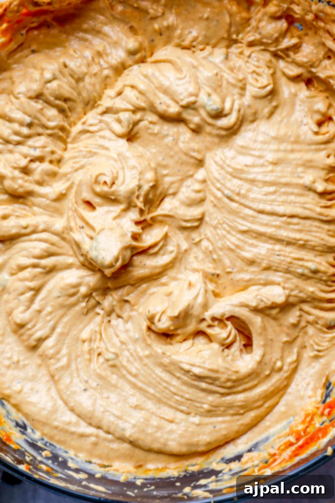 A close-up shot of perfectly whipped white frosting, showcasing its smooth and creamy texture.