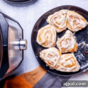 A plate of instant pot cinnamon rolls on a table.