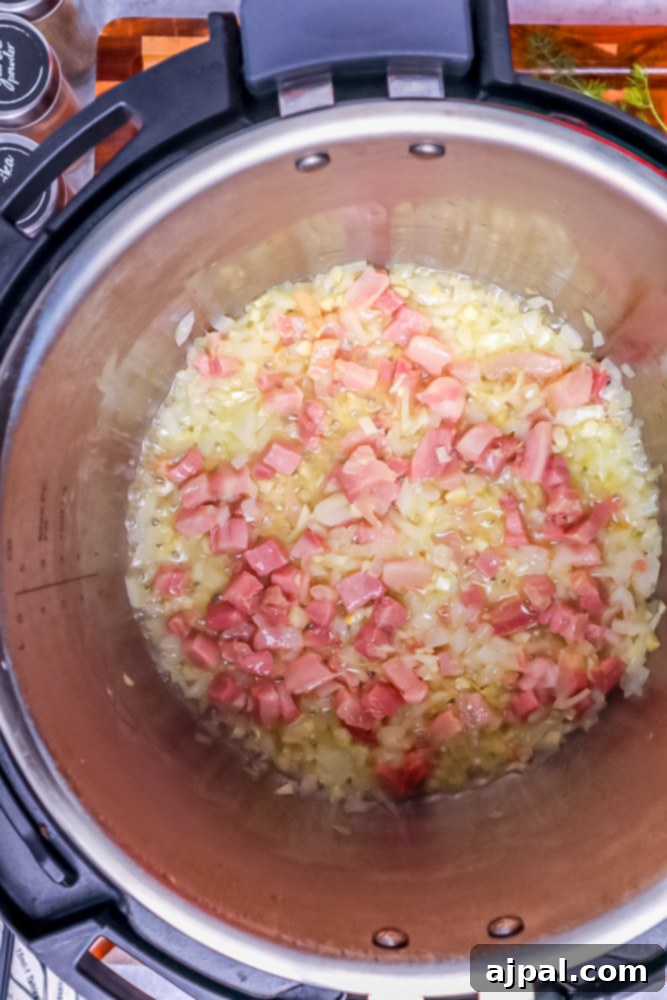 Creamy Instant Pot Keto Broccoli Cheddar Soup 7 Diced bacon sizzling in melted butter within the Instant Pot, starting to crisp and render its delicious fats.