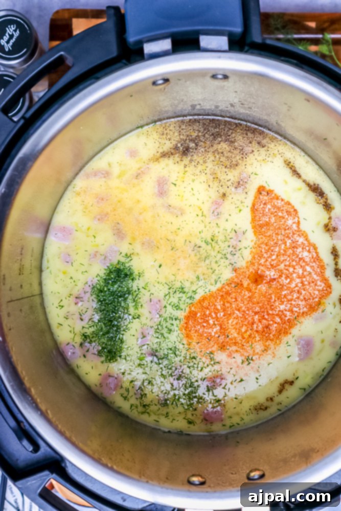 Creamy Instant Pot Keto Broccoli Cheddar Soup 8 A mix of seasonings being added to the Instant Pot, joining the sautéed butter and bacon, infusing the pot with aromatic flavors.